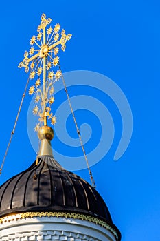 Close-up of golden cross on dome of orthodox church