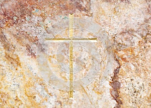 Close-up on golden cross on luxerios marble background.