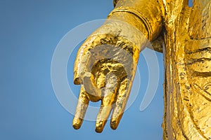 Close up on a golden hand doing Buddhist mudra gesture called dharmachakra.