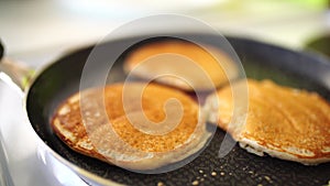 Close-up of golden punkies in a frying pan, light white haze.