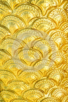 Golden yellow serpent scale statue texture with seamless patterns for background