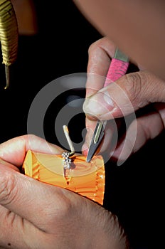 Close up Goldsmith cutting rubber mold in jewelry process unfinished