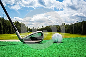 Close-up of a golf ball and a golf club