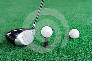Close-up of a golf ball and a golf wood on a driving range