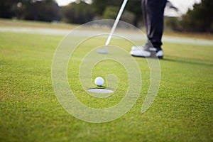 Close up of golf ball and a hole