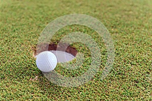 Close up of golf ball near hole