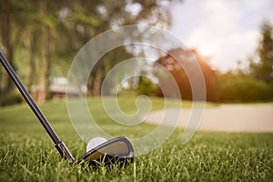 Close up of golf club and ball.