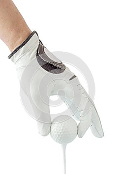 Close up the golfer hand in glove holding the golf ball with tee