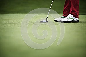 Close-up of golfer putting