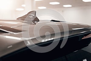 Close-up GPS antenna shark fin shape on a roof of car for radio navigation system