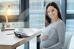 Close up of gracious pregnant woman with a smile