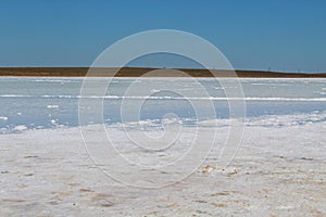 Close-up of grains of salt on the sand of the salt lake in the Astrakhan region