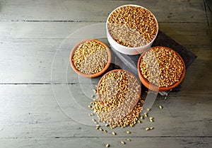 close up of grains and wheat ears on white background