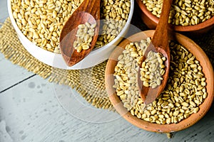 close up of grains and wheat ears on white background