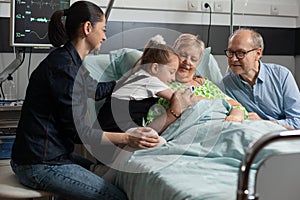 Close-up of granddaughter supporting grandmother hugging her during medicine therapy