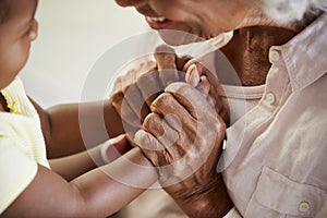 Close Up Of Grandmother Holding Hands With Baby Granddaughter Playing Game Together photo