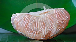 Close-up of a grapefruit that is peeled and the orange pulp is visible