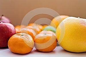 Close-up of grapefruit, tangerines and red apples