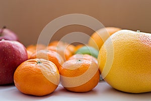 Close-up of grapefruit, tangerines and red apples