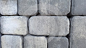 Close-up of gray cobblestone wall showing texture and pattern