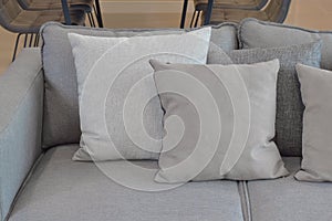 Close up of gray color pillows on sofa in modern living room at home