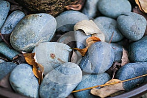 Close up of gray and dark blue smooth river rock. Selective focus