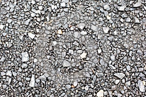 Close up of gray macadam stones on ground photo