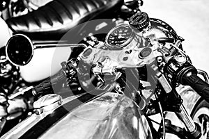 Close-up grayscale shot of an old motorcycle control panel