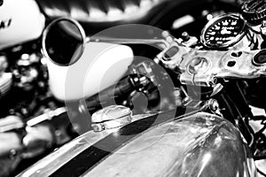 Close-up grayscale shot of an old motorcycle control panel