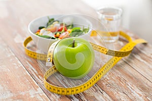 Close up of green apple and measuring tape photo