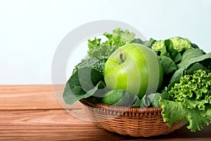 close up green apple with mixed green vegetable in basket and