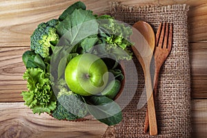 close up green apple with mixed green vegetable in a basket and