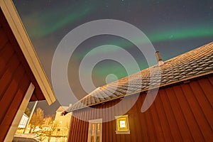 Close up of green aurora northern lights and stars in Lofoten islands, Norway. Sky with polar lights at night in winter season.