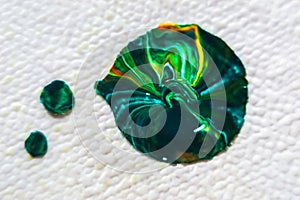 Close up of a green and blue agate gemstone on white background. Macro shot of paint.