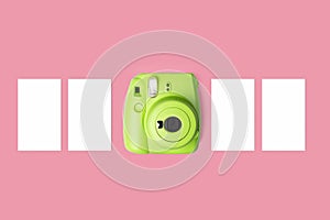 close-up, green camera, photo, pastel pink background
