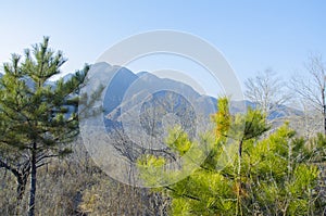 Mountains foggy white blue sky. Chinese autumn mountains.