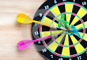 Close up green darts arrow on the target center of dartboard for business goal concept - Flay lay