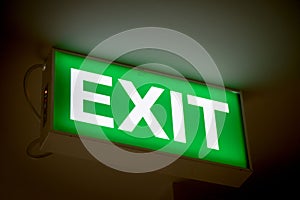 Close up Green Exit sign on door in the building