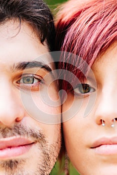Close-up of the green eyes of a young man and woman, with their faces together. Concept of health, unity, cataracts, eye problems