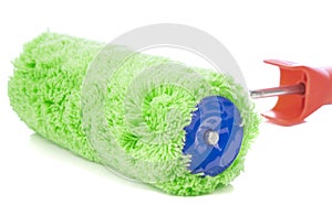 A close up of a green fluffy paint roller