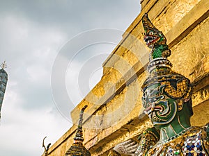 Close up Green Giant Lift golden Pagoda in Wat Phrakaew temple Bangkok Thailand.