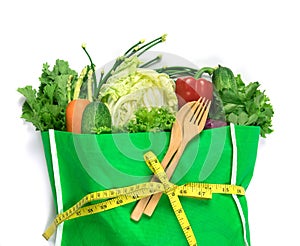 close up a  green grocery bag of mixed organic green vegetables on white , healthy organic green food shopping and diet healthcare