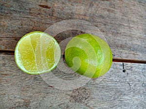 Close up on green lemon on wooden table