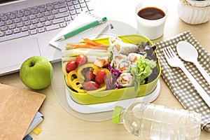 Close up green Lunch box on the work place of working desk ,