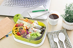 Close up green Lunch box on the work place of working desk ,Healthy eating clean food habits for diet and health care concept