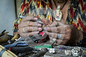 Jeweler`s hands working on his craft photo