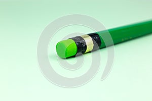 Close up green pencil with eraser on the green background. Minimalism, original and creative photo photo