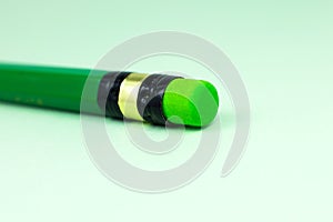 Close up green pencil with eraser on the green background. Minimalism, original and creative photo photo