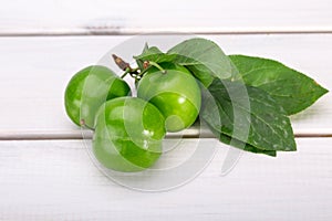 Close Up Of Green Plums Or Greengage fruit with leaves Isolated photo