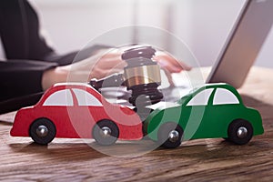 Close-up Of Green And Red Car On Wooden Desk